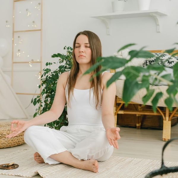 Person in a meditative yoga pose, radiating calm energy.